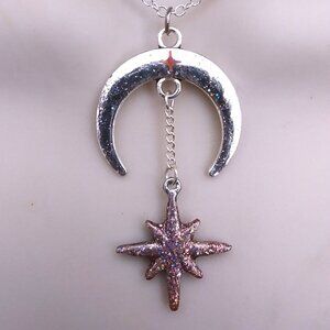 Crescent sparkling silver moon with a rose pink sparkling north star